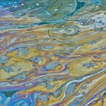 Oily polluted water surface in a Texas waterway. This can be the