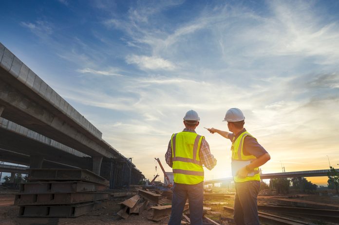 Asian,Architect,And,Mature,Supervisors,Meeting,At,Construction,Site,Multiethnic